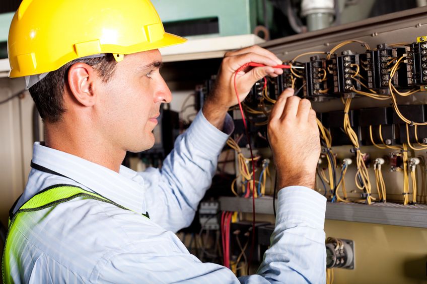 12431512-male-electrician-testing-industrial-machine